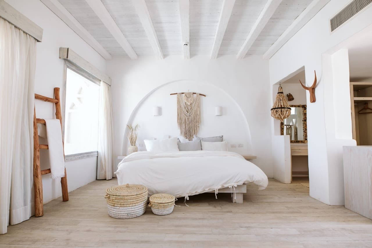 Serenity Suite double bed with warm timber and woven details
